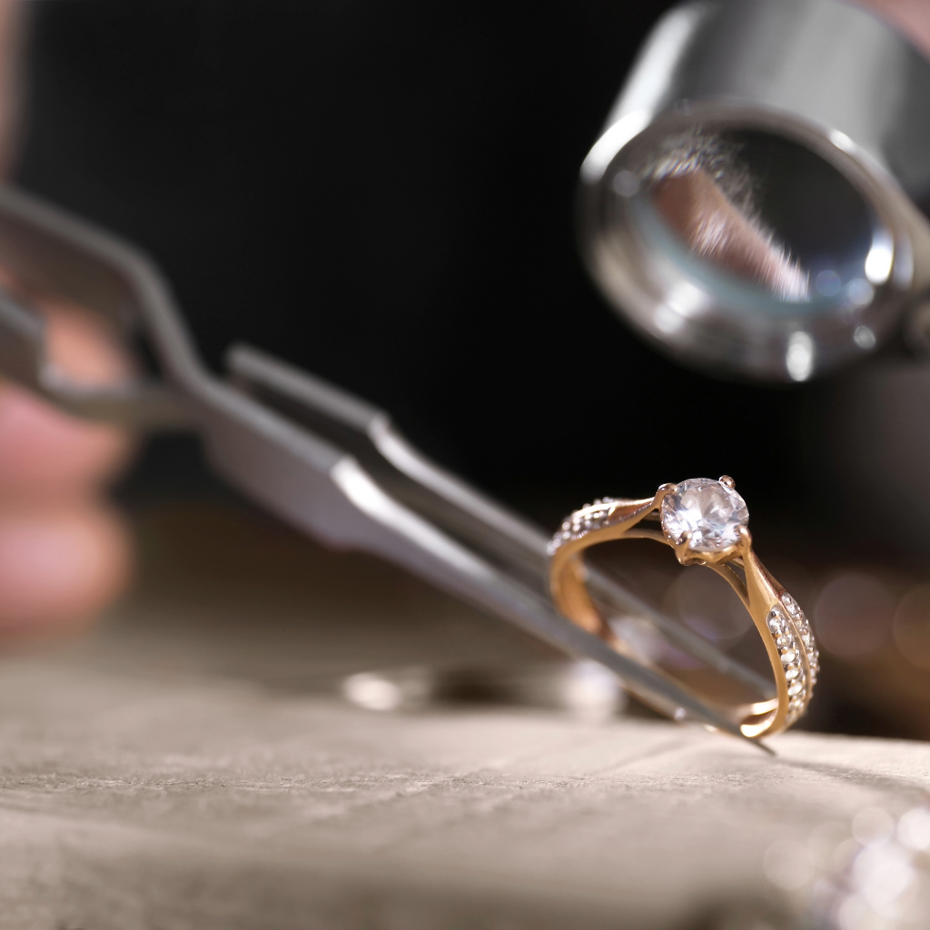 A jewelry appraiser verifies the authenticity of a diamond ring.
