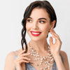 A woman wearing a pair of pearl earrings and necklace. She's smiling.Protect your jewelry by following these 5 tips.