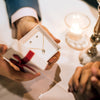A man gives a woman a heart-shaped necklace and earrings as a Valentine's Day Gift idea.