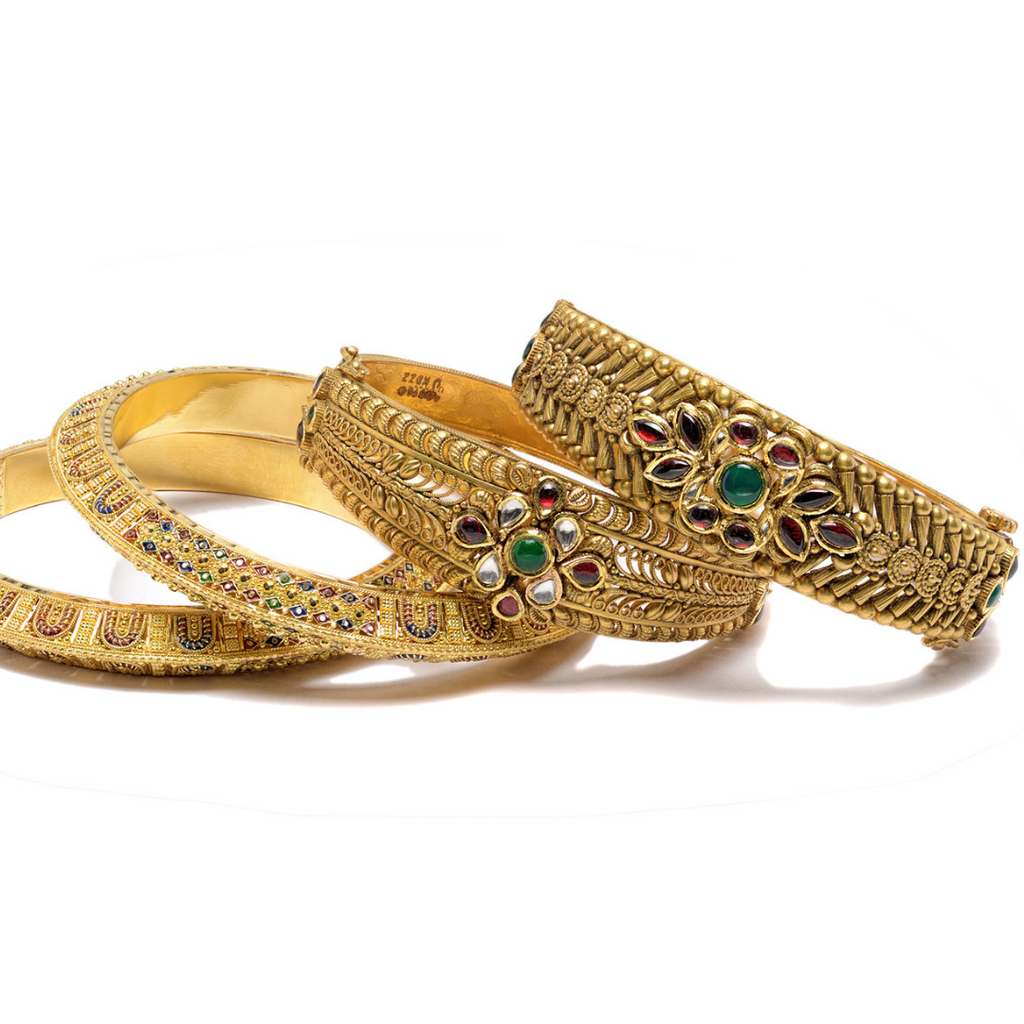 Four antique bracelets in 14k gold with intricate roping designs and prescious gemstones.