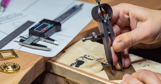 A master jeweler uses tool to create custom design jewelry for a client. 
